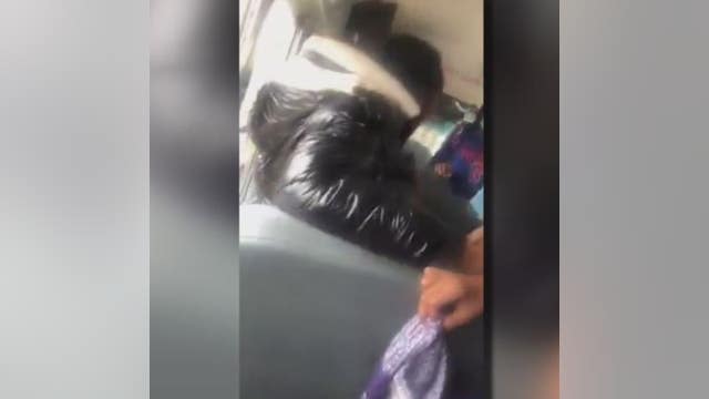 Video shows woman restrain small child, sit on him in school bus struggle