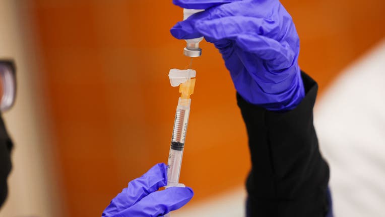 FILE - A Pfizer COVID-19 vaccine booster shot is prepped to be administered at the Mount Sinai South Nassau Vaxmobile that visited Freeport High School, in Freeport, New York, on Tuesday, November 30, 2021. (Photo by Steve Pfost/Newsday RM via Getty Images)