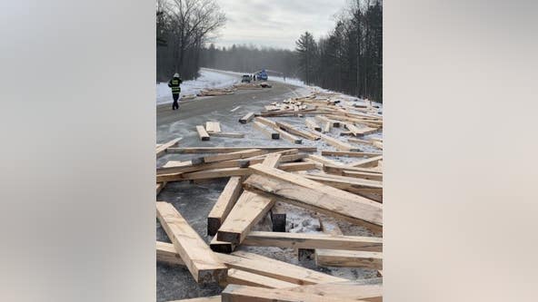 Truck driver loses control and crashes, spilling wood across I-75 in Northern Michigan