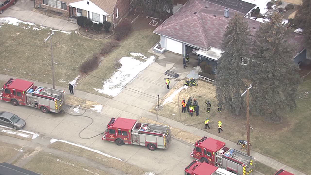 Firefighters investigating a double-fatal house fire on Detroit's west side
