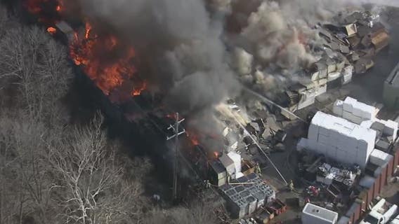 Fire still burning at roofing company, but is under control