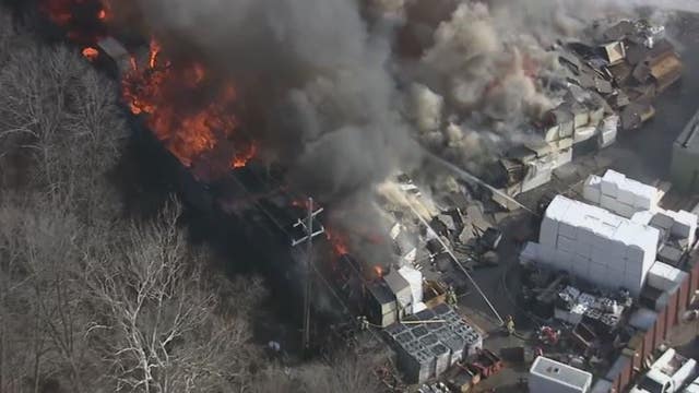 Fire still burning at roofing company, but is under control