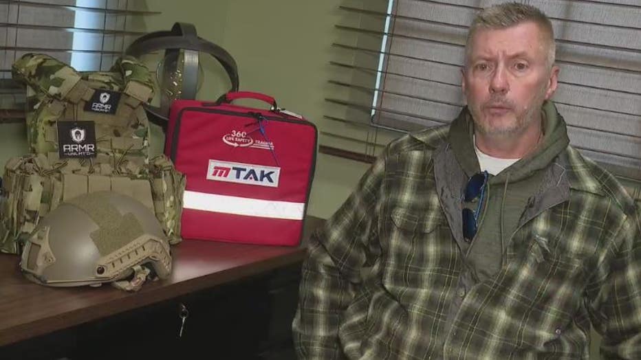 Huron Valley Guns owner Ed Swadish with defensive supplies he is selling at cost to help Ukrainian fighters overseas.