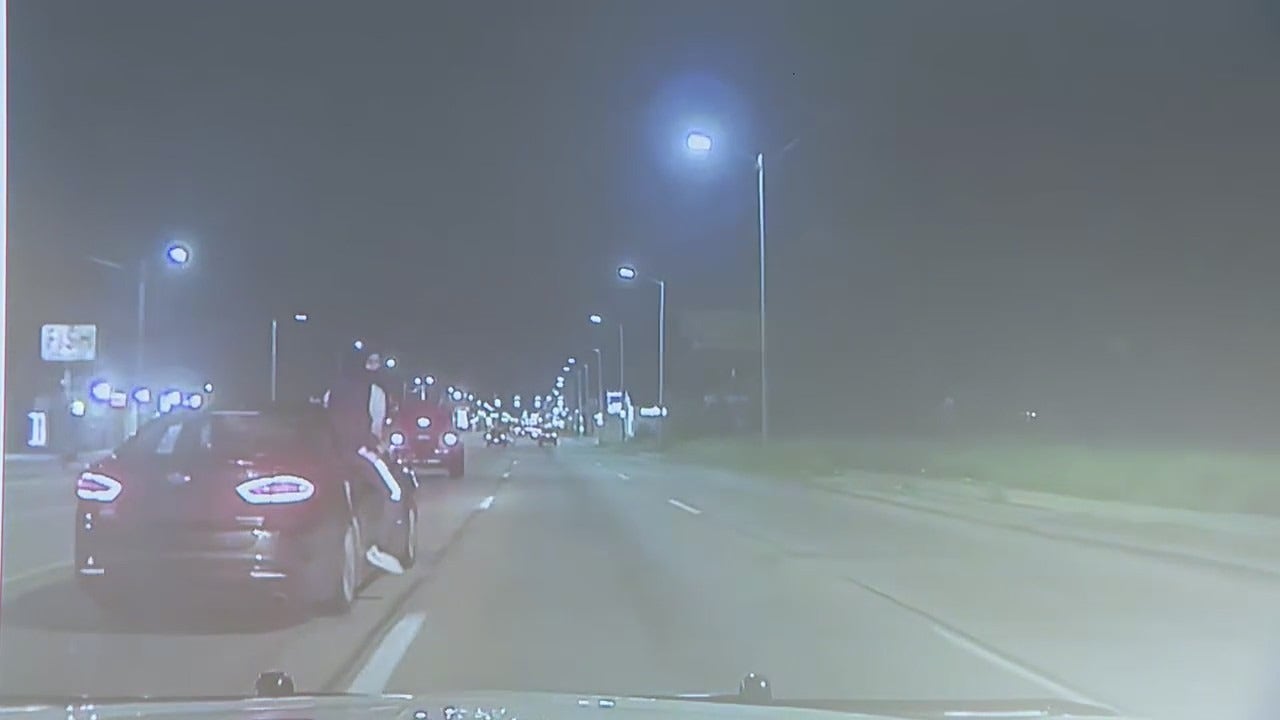 Suspect hanging out of car fires 8 shots at Detroit police during attempted reckless driving stop