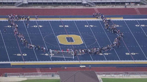 Oxford High School students walk out for school safety, form U on football field
