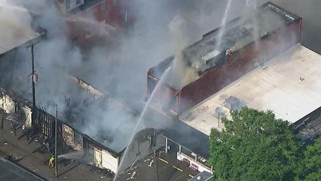 Multiple departments fight downtown Holly fire