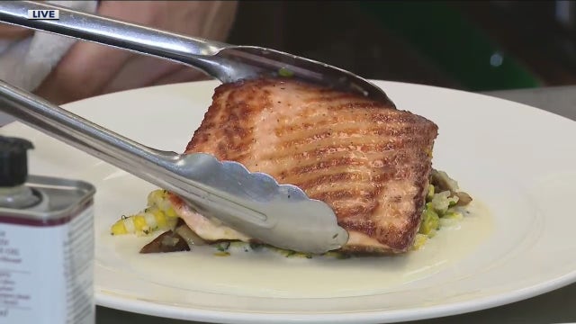 Preparing pan roasted salmon with Michigan sweet corn