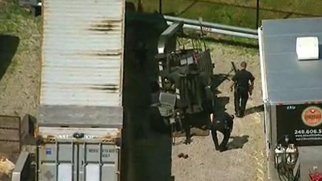 Man dies after getting pinned under wood chipper in Troy