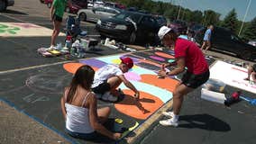 Anchor Bay High School seniors paint their parking spaces ahead of the school year