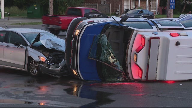 Ambulance collides with car, tips over in Detroit intersection