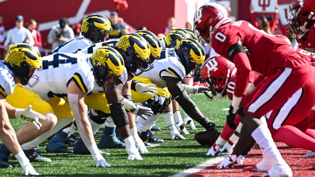 Michigan running back coach Mike Hart carted off field on backboard