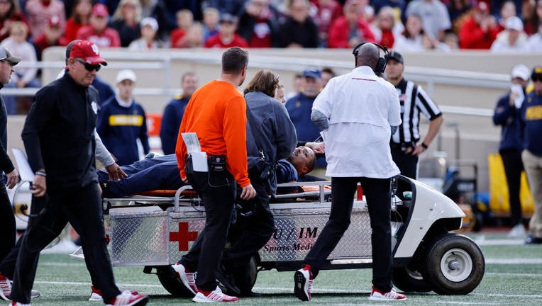 Michigan running back coach Mike Hart back in Ann Arbor after collapsing  mid-game at Indiana