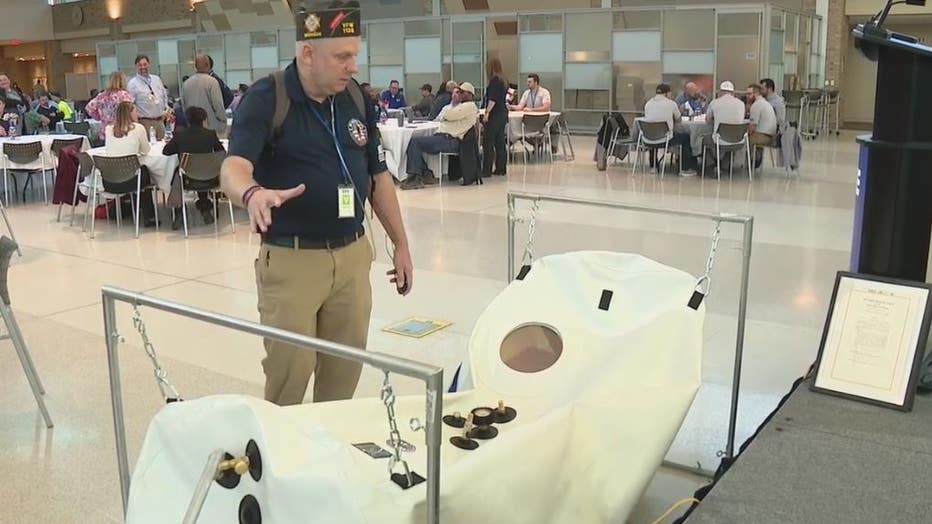 Military veteran Kevin Hensley with a hyperbaric chamber.