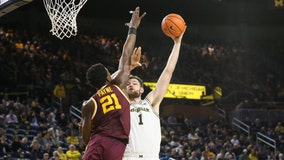 Dickinson scores 28, Michigan holds off Minnesota 60-56