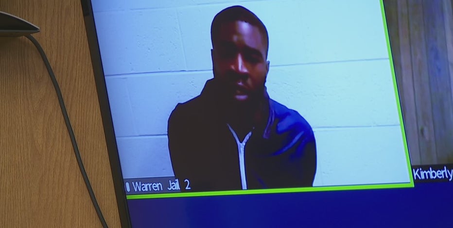 Man accused of shooting at Warren police claims he was giving officer weapon