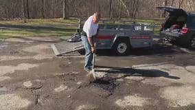 Frustrated Waterford man patches neighborhood potholes himself