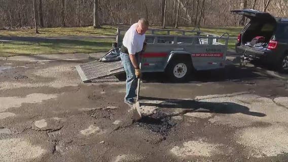 Frustrated Waterford man patches neighborhood potholes himself