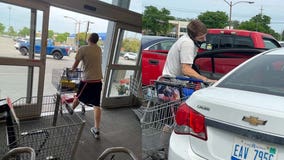 Man walks out of Bloomfield Township Kroger with energy drinks, iced tea, and Kit Kat candy bars