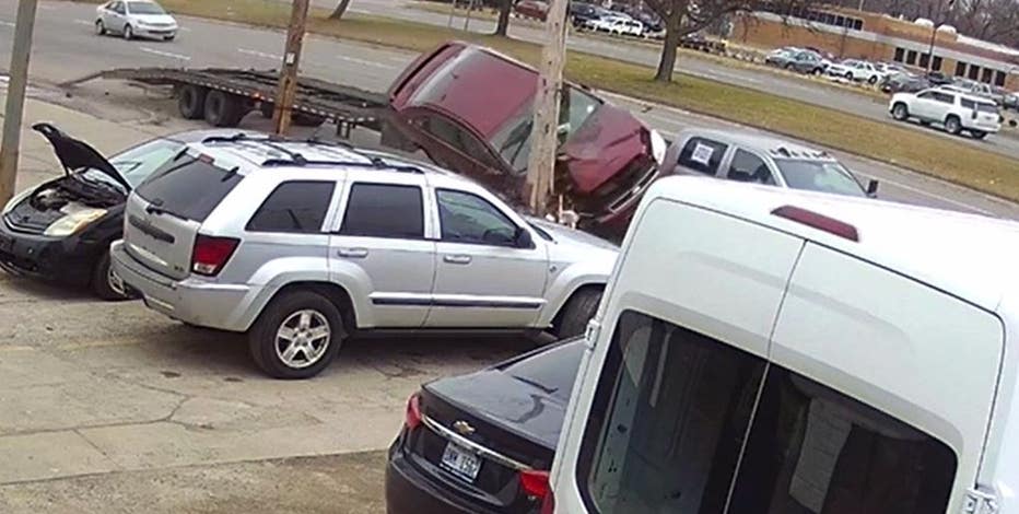 Car flies up, crashes after using empty car hauler as ramp in Detroit