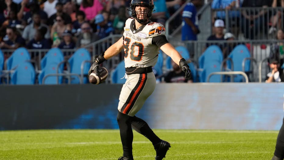 TORONTO, CANADA - JULY 3: Mathieu Betts #90 of the BC Lions holds onto the ball after sacking a Toronto Argonauts quarterback at BMO Field on July 3, 2023 in Toronto, Canada. (Photo by John E. Sokolowski/Getty Images)