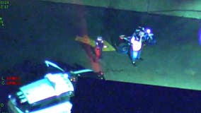 Motorcyclist does donuts and wheelies around cop car before fleeing, running out of gas