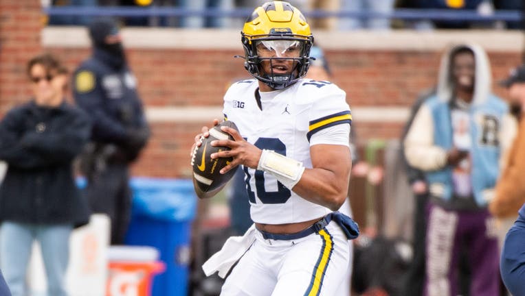 NN ARBOR, MICHIGAN - APRIL 20: Alex Orji #10 of the Michigan Wolverines looks to throw the ball downfield during the Spring Football Game at Michigan Stadium on April 20, 2024 in Ann Arbor, Michigan. (Photo by Aaron J. Thornton/Getty Images)