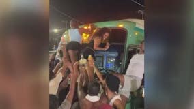 Women climb Detroit bus to twerk during street takeover by more than 100 party-goers