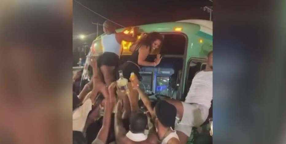 Women climb Detroit bus to twerk during street takeover by more than 100 party-goers