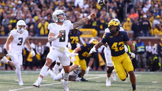 Dillon Gabriel throws a TD pass and runs for a score to lead No. 1 Oregon to 38-17 win over Michigan