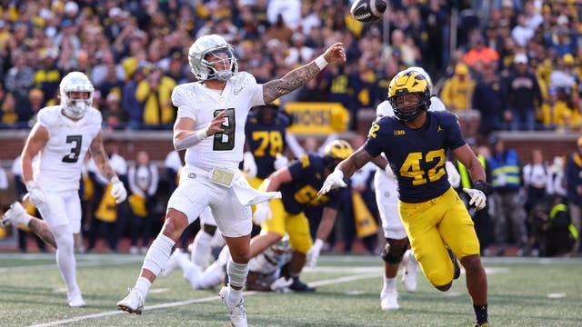 Dillon Gabriel throws a TD pass and runs for a score to lead No. 1 Oregon to 38-17 win over Michigan