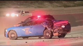 Semi-truck driver arrested after crashing into Michigan State Police cruisers on I-75