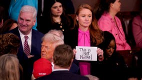 'This is not normal': Watch Democrat's sign ripped away as Trump enters
