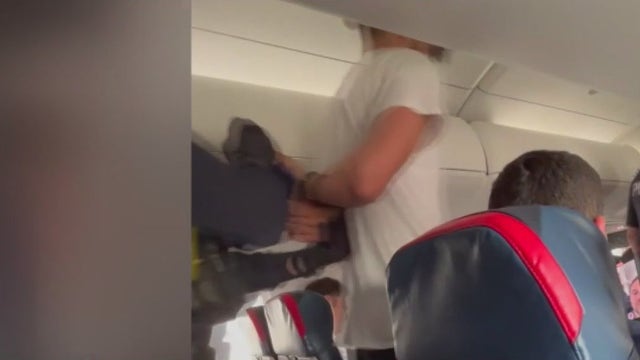 Nebraska man arrested after trying to open Detroit-bound flight's emergency door