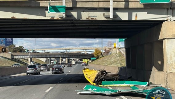 Garbage truck hits overpass sign on I-94 in Detroit