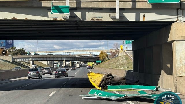 Garbage truck hits overpass sign on I-94 in Detroit