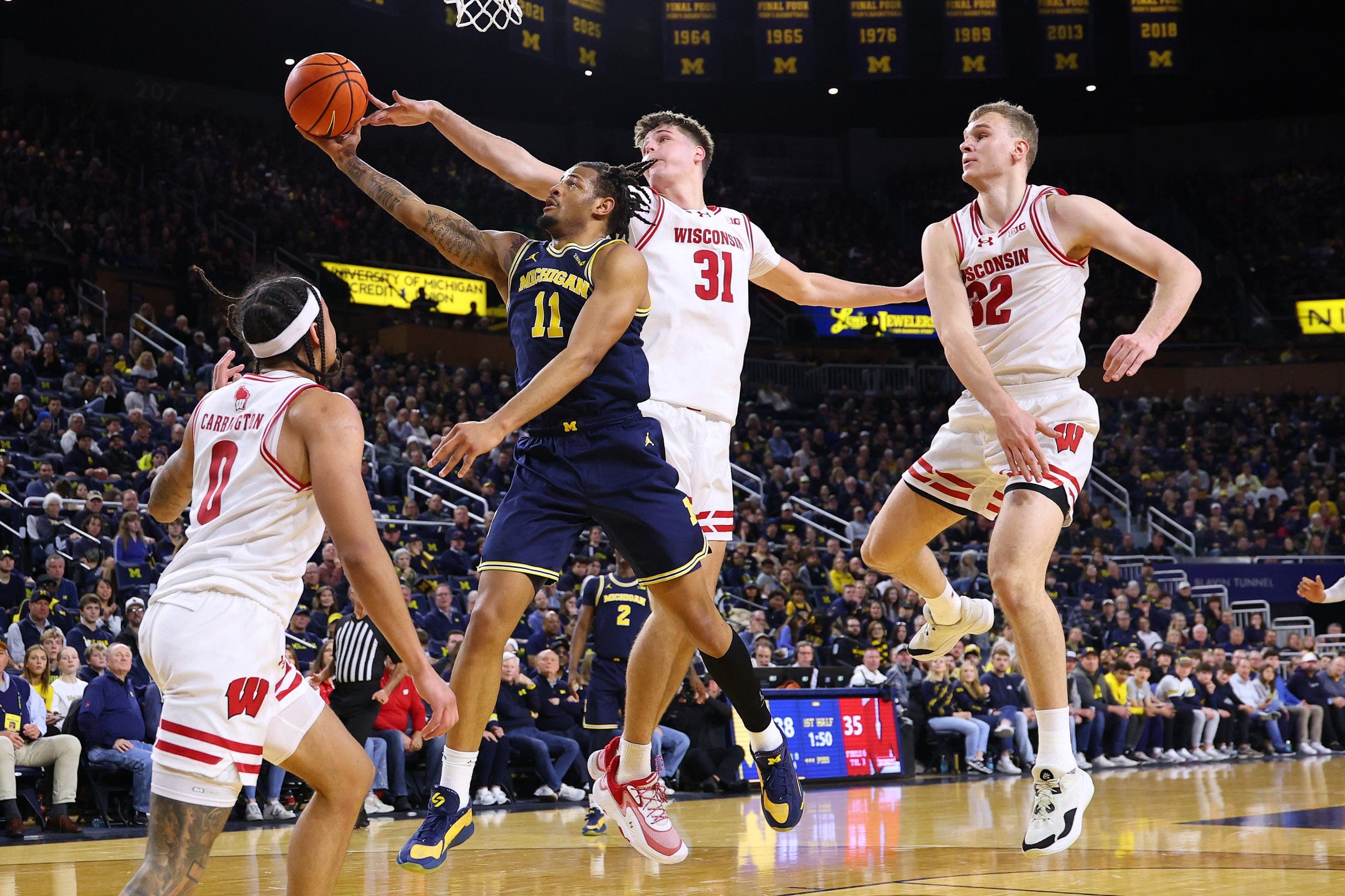 Wisconsin beats No. 2 Michigan 91-88 to give Wolverines their 1st loss of the season