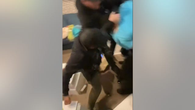 Detroit police officer caught on camera punching man in cuffs while pursuing suspect