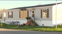 Man found dead, others injured in burning mobile home in Monroe
