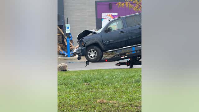 Truck runs through apartment sign, into Brownstown Taco Bell building