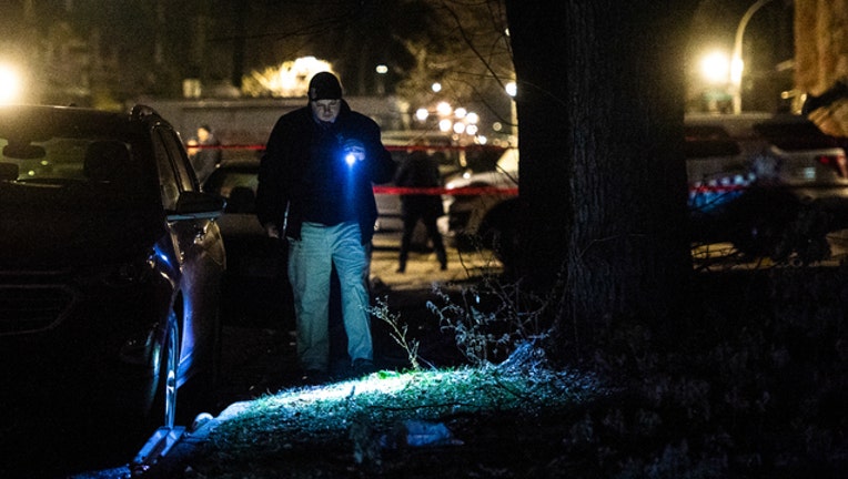02091f9a-Chicago Police look for clues after a woman is shot dead.