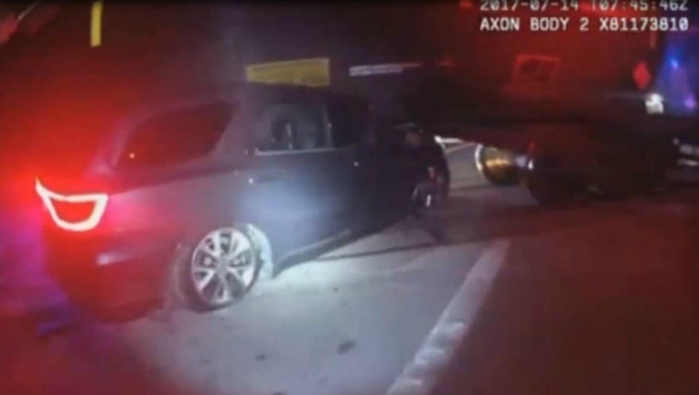 Image from La Marque Texas Police Department body cam shows car stuck under train
