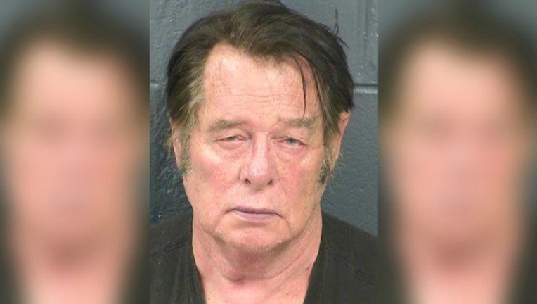 14f732d6-Larry Mitchell Hopkins was arrested on felony weapons charges after his group started detaining immigrants at the border