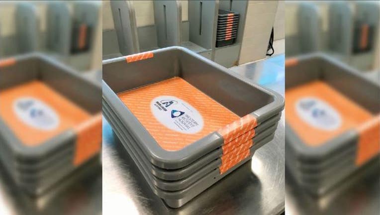 35c4d16d-Airport puts germ-killing mats inside security bins