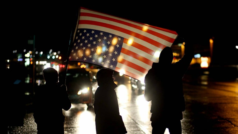 58492cb8-GETTY american flag protest_1506637836540.jpg