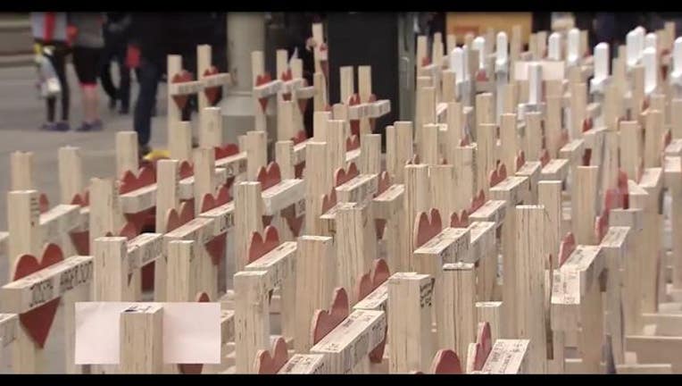 5daf7e1f-Crosses on Michigan Avenue to honor victims of violence