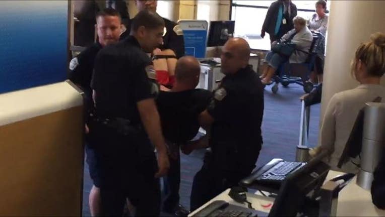 6a442c09-Airplane passenger is hogtied and arrested at LAX