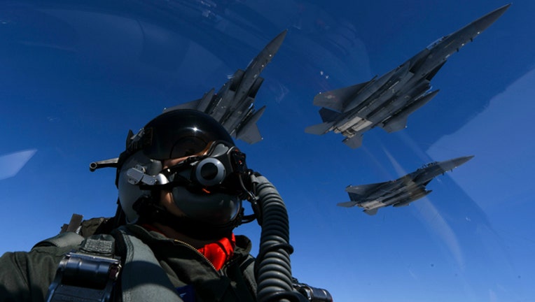 Two US Air Force B-1B Lancers fly with South Korean fighter jets over Korean peninsula.