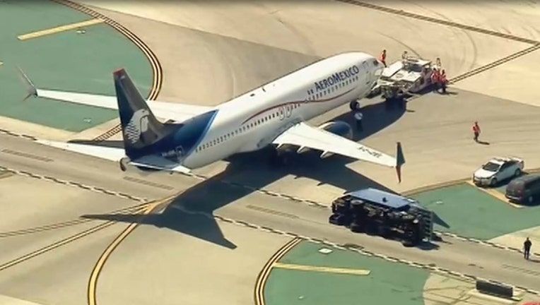 8410ae8e-An Aeromexico plane clipped a truck on the runway at LAX Saturday, injuring 8 people.