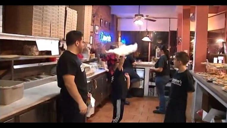 c90a2254-Michael and Nicholas Testa are getting worldwide attention for their pizza-throwing skills
