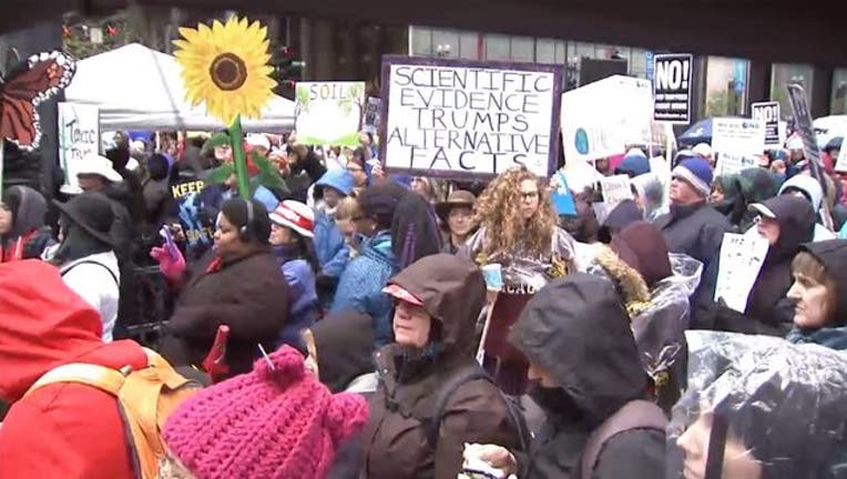 Marchers at Chicago's climate rally wore raincoats and gloves in the cold April rain.